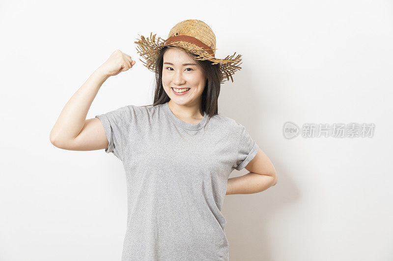 Young asian woman wearing straw hat standing over white backgroundใ